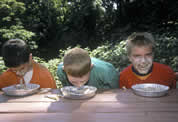 Photo of boys with whipped cream on their faces